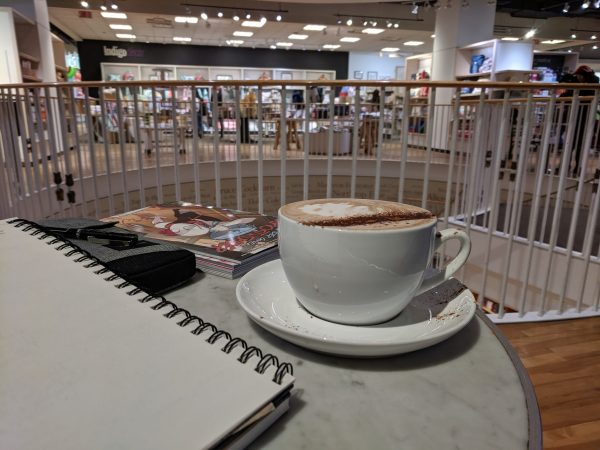 A notebook in a bookstore coffeehouse, with coffe.